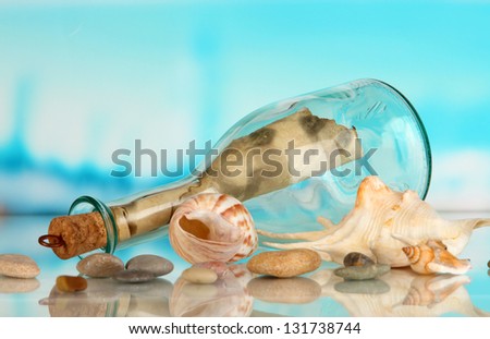 Original glass bottle with letter on sea background