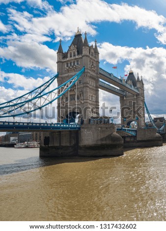 View of Tower Bridge over the River Thames in London, UK on a sunny day.