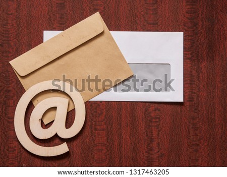 sign e-mail, paper letters on a wooden background table. Internet, correspondence.