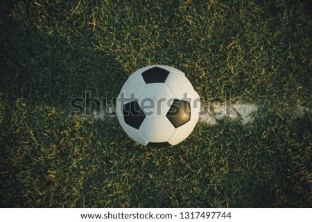 Top view of the ball for street soccer football on green grass. Film picture style.