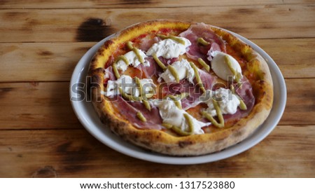 Italian pizza on wooden table