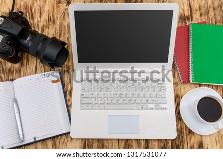 Digital camera with laptop and color sampler on desk