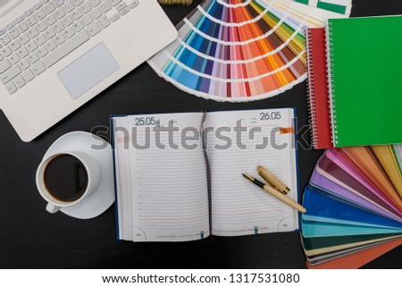Color sampler with laptop and diary in office