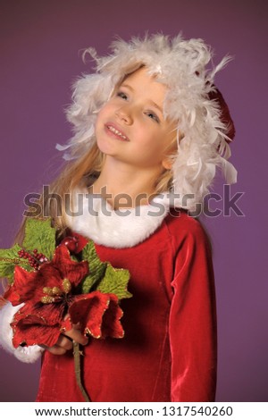 portrait of a beautiful blonde girl in a Christmas hat with a Christmas bouquet