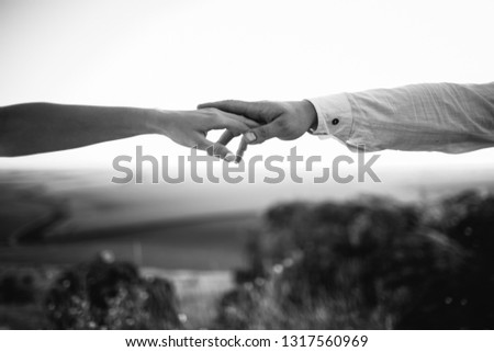 Man and woman hold their hands like Adam and God