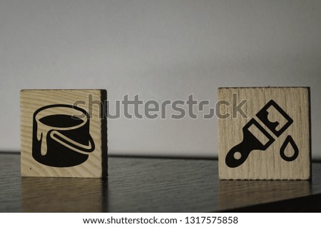paint cans and brushes icons on wooden cubes