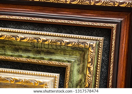 Lined up old wooden vintage art frames. Close-up fragment. For promotional image