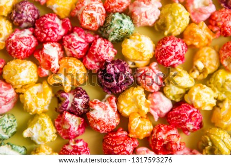 multi-colored popcorn on a bright yellow background.concept of cinema,copy spase