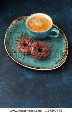 Glazed mini donuts with coffee  on dark background. Party food concept with copy space