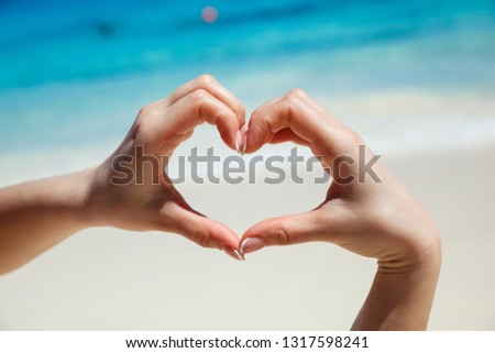 Hands in shape of the heart. Tropical beach. Love concept Royalty-Free Stock Photo #1317598241