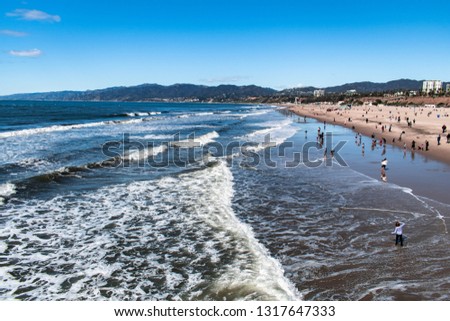 The pacific coastline of Santa Monica, California.  People enjoying the beach on a warm day. This was taken on a warm winter day, just after rain where visibility was much clearer than it usually is.