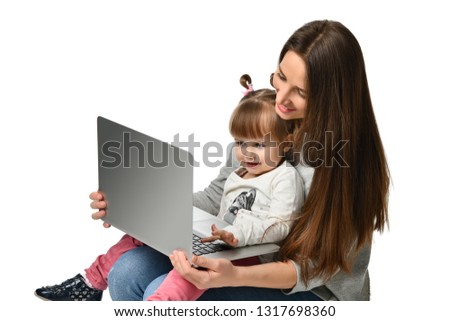 happy mother with adorable little girl with laptop . childhood, parenting and technology concept . isolated
