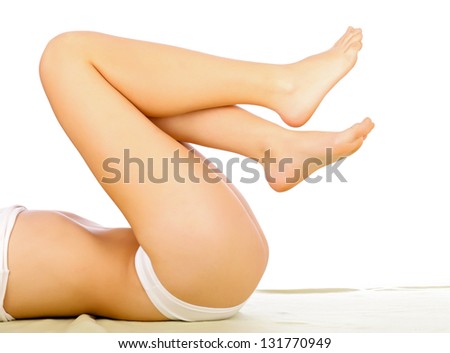 Woman Lying With Her Legs Lifted Isolated On White.