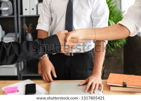 The business worker shaking hands together,sign and symbol of success deal and trust,after meeting,at office