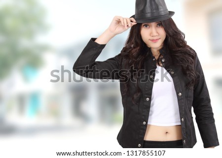 young asian woman with black jacket and blur background
