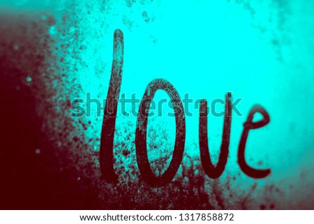 The word "love" on the glass. Bright blue color. 