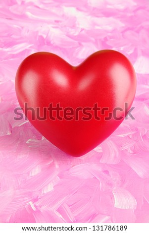 Decorative red heart on color background