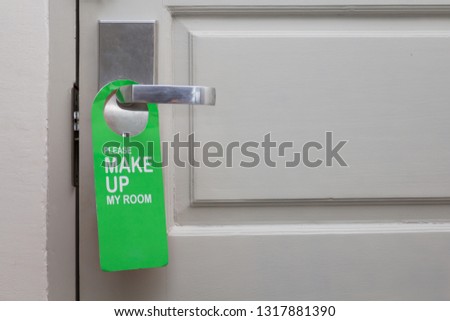 Hotel hanger sign on door knob.Please make up the room
