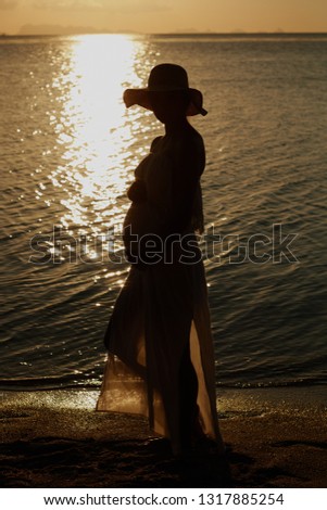 Outdoor  photo of young pregnant beautiful lady in hat. Summer Beach travel. Summer vibes