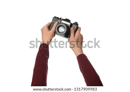 Vintage camera in hand isolated on white background. Photography and memories.
