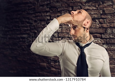 Businessman with multiple personality changes the mask Royalty-Free Stock Photo #1317910784
