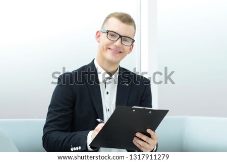 close up. smiling businessman signs a business document