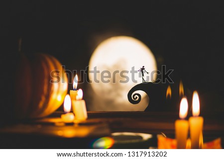 Silhouette of a man or a poet on the background of the moon and pumpkins. Feast of the day of the dead or Halloween. Small world and ciliate