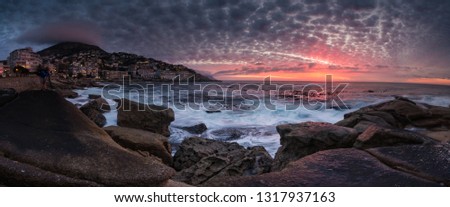 Wide angle view of a seascape scene in Seapoint in Cape town south africa Royalty-Free Stock Photo #1317937163