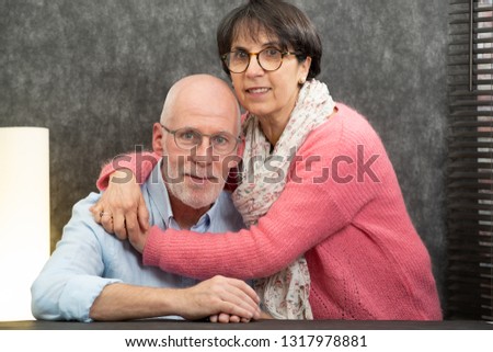 a portrait of an happy senior couple at home