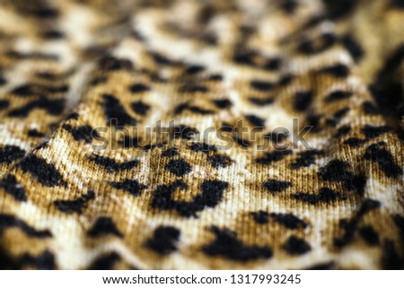 Leopard print fabric close up background. Selective focus.

