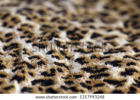 Leopard print fabric close up background. Selective focus.

