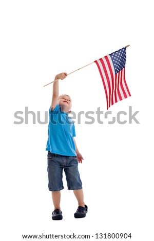 Cute 3 year old boy flying an American flag isolated on a white background