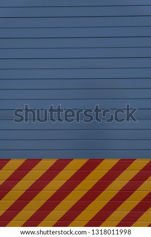 Hangar door with red and yellow stripped on lower