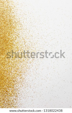 Golden glitter on white background, top view