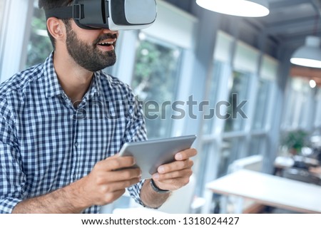 Business man using virtual reality headset in the office