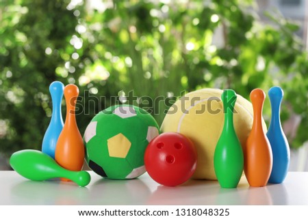 Set of different toys on table against blurred background