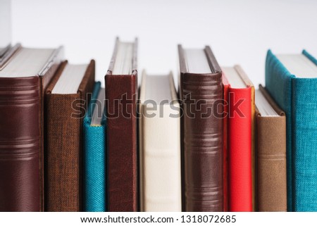multi-colored albums of different sizes and textures on a white background