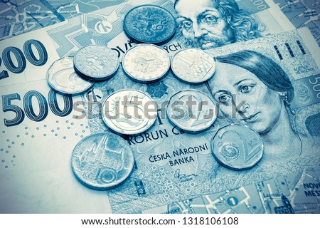 Money of Czech Republic, banknotes and coins on tourist map of Prague, travel toned background with vintage effect