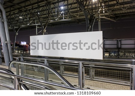 Blank billboard banner in the train station for advertising mockup at night.