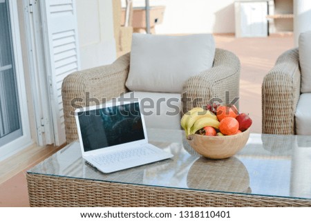 Fruits salad in bowl on glass wooden table background