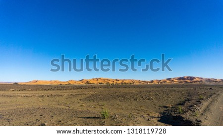 Random path in Morocco, passing by sandy town somewhere in the area between Ouarzazate and Merzouga. Desert view for wallpaper or background.