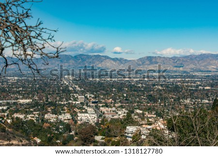 Los Angeles city. Beautiful houses. View from the mountain. Serpentine California mountains. Summer. Beautiful sky. USA.
