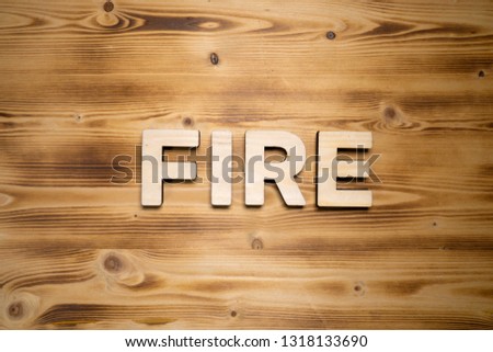 FIRE word made with building blocks on wooden board