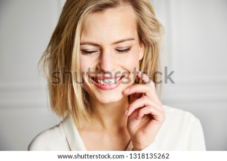 Gorgeous smiling woman with eyes closed Royalty-Free Stock Photo #1318135262