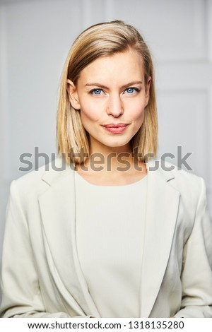Beautiful blue eyed woman in smart business attire Royalty-Free Stock Photo #1318135280