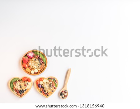 Healthy  food  in  wooden  plates  and  spoon  on  white  background  for  reduce  cholesterol