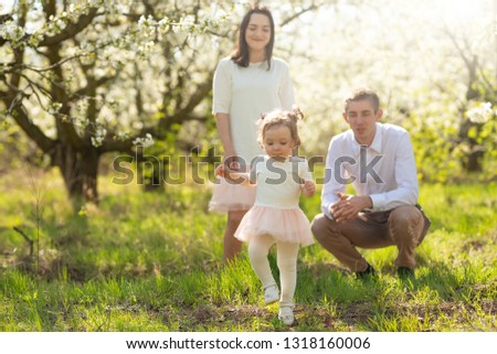 Family on vacation in the park, the sun, a pleasant summer spring mood. Relaxing in the park and walking radar with a child