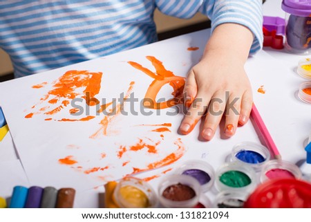 Hands of painting little boy and the table for creativity