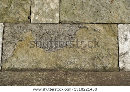 Natural stone wall lovingly bricked or misplaced photographed in a park in Germany                            