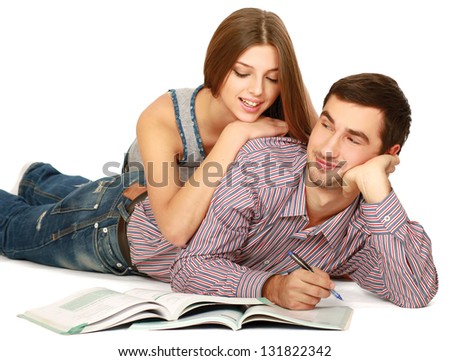 A young couple lying on the floor isolated on white background